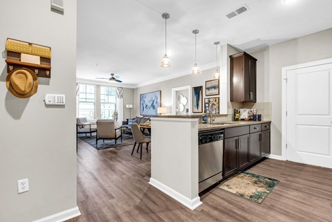 an open kitchen and living room with a table and chairs